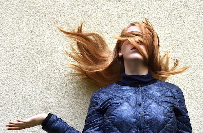 red haired woman hair flicking