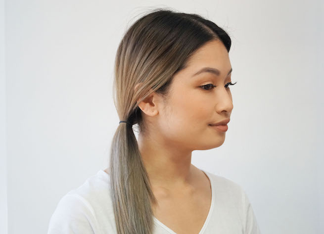 Woman with pony tail about to demonstrate the fishtail braid hairstyle