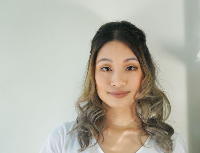 Front on photo of woman with half up half down hairstyle