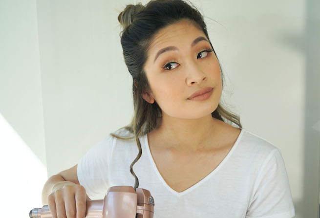 woman curling her hair using the vs sassoon curl secret multi curl