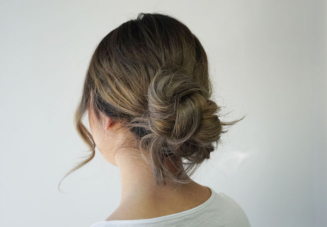 woman modelling messy bun hairstyle back view