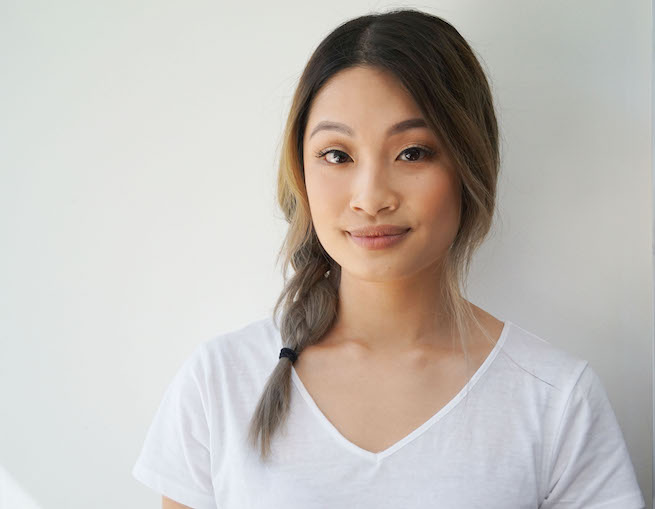 Front on photo of woman with side swept braid hairstyle