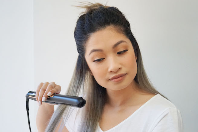 Woman straightening hair using the vs sassoon 3Q digital straightener 