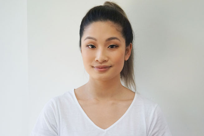 Front on photo of woman with a sleek pony tail hair style