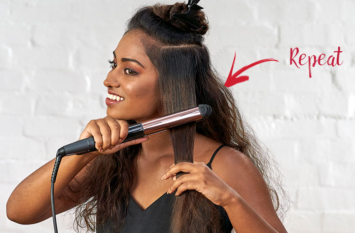 Woman using a hair straightener