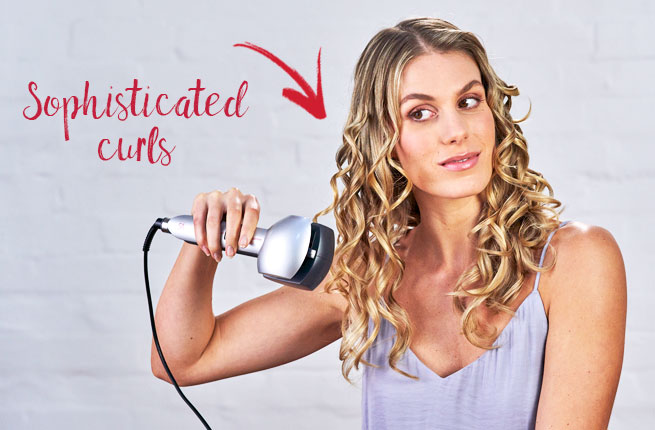 Woman using automatic curler